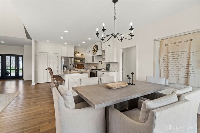 2164 Northbridge Trl, Troy, OH 45373 - dining room featuring wood finished floors, a chandelier, and recessed lighting