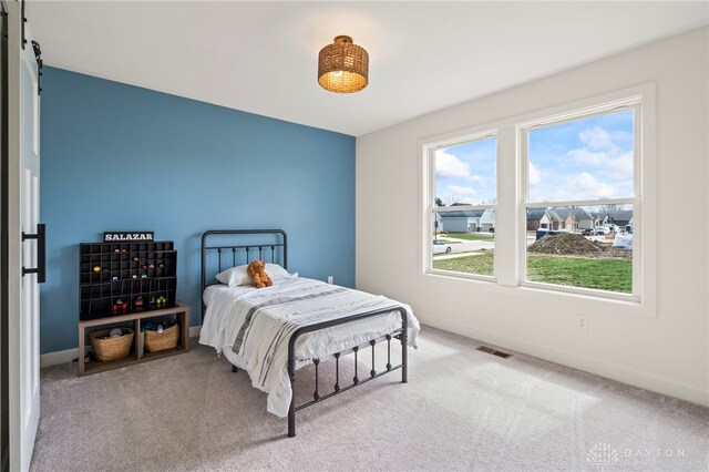 2164 Northbridge Trl, Troy, OH 45373 - carpeted bedroom with baseboards and a barn door