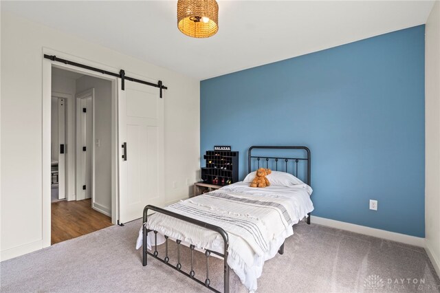 2164 Northbridge Trl, Troy, OH 45373 - carpeted bedroom featuring a barn door and baseboards