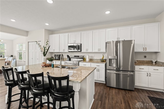 3059 Canvasback Ct, Franklin Twp, OH 45005 - kitchen featuring a sink, dark wood-style flooring, white cabinetry, stainless steel appliances, and light stone counters