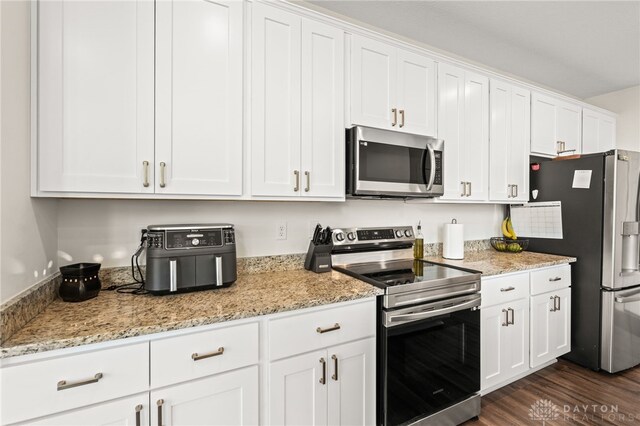 3059 Canvasback Ct, Franklin Twp, OH 45005 - kitchen with dark wood-type flooring, white cabinets, light stone countertops, and stainless steel appliances