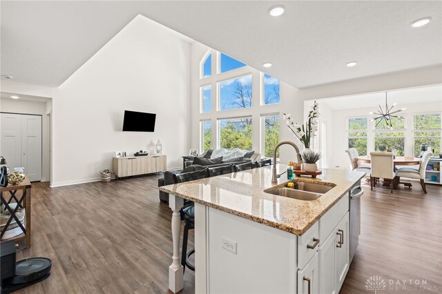 3059 Canvasback Ct, Franklin Twp, OH 45005 - kitchen with a notable chandelier, open floor plan, a kitchen island with sink, dark wood finished floors, and a sink