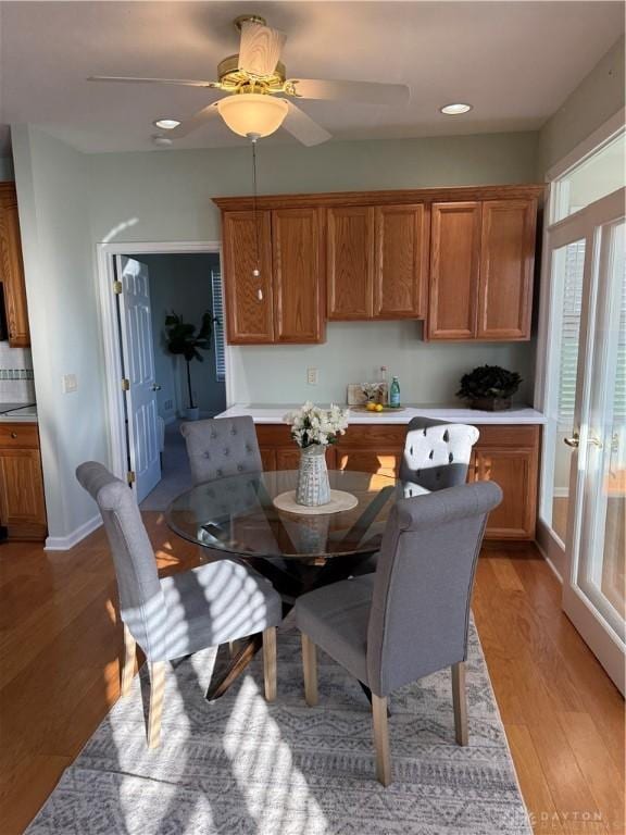 dining area with recessed lighting, ceiling fan, light wood-type flooring, and baseboards