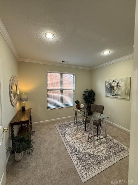carpeted office featuring baseboards, a textured ceiling, and crown molding