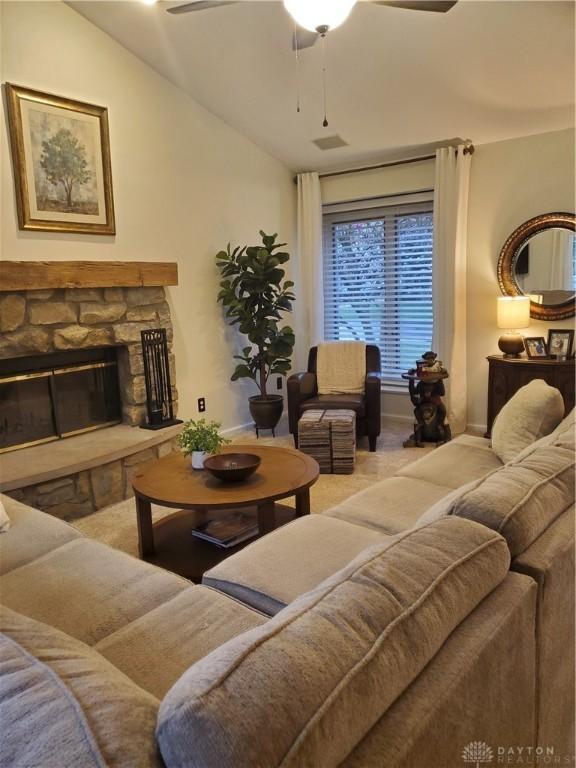 living room with vaulted ceiling, ceiling fan, carpet floors, and baseboards