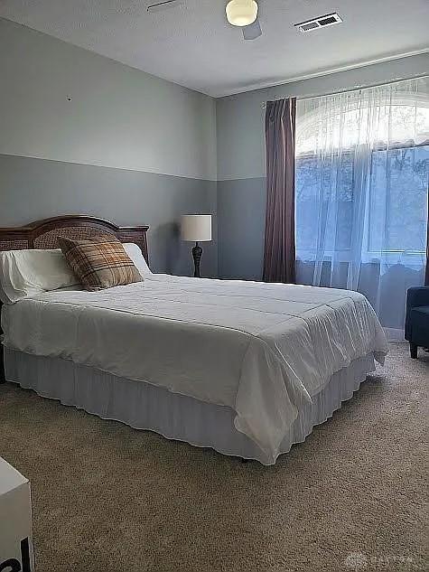 bedroom featuring visible vents and carpet floors