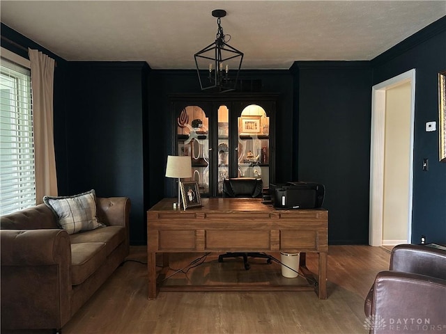 home office featuring crown molding and wood finished floors