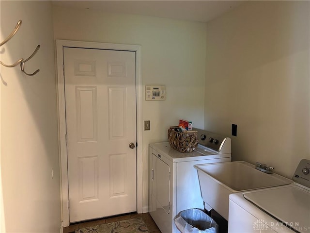 clothes washing area featuring independent washer and dryer and laundry area