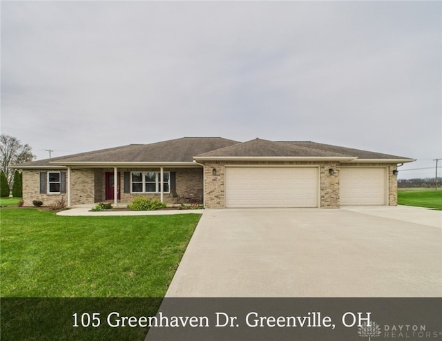 view of front facade with a garage, concrete driveway, a front lawn, and brick siding