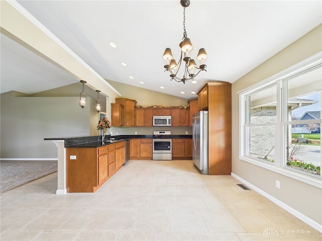 kitchen with a chandelier, a peninsula, visible vents, brown cabinetry, and appliances with stainless steel finishes