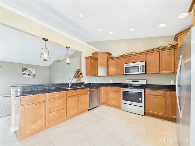 kitchen with a peninsula, appliances with stainless steel finishes, a sink, lofted ceiling, and brown cabinets