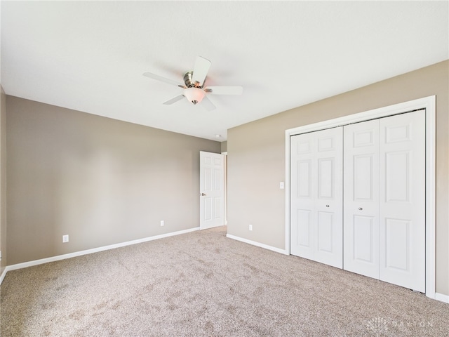 unfurnished bedroom with a closet, baseboards, a ceiling fan, and carpet floors