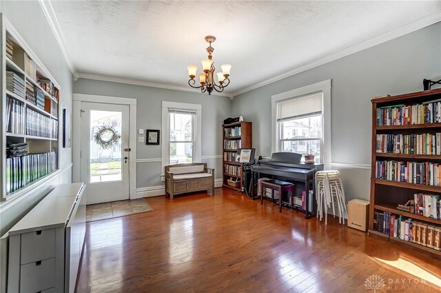 357 High St, Wilmington, OH 45177 - interior space with wood finished floors, crown molding, and a notable chandelier