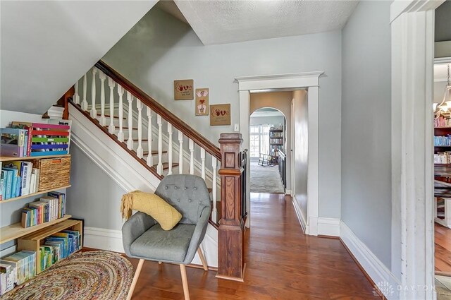 357 High St, Wilmington, OH 45177 - stairs featuring arched walkways, wood finished floors, and baseboards