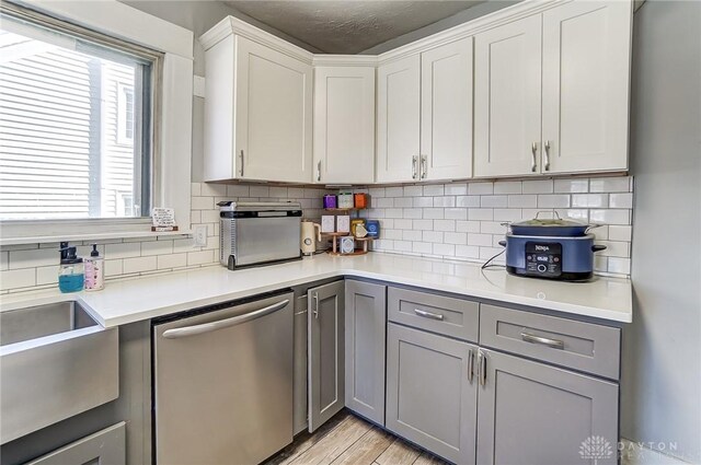 357 High St, Wilmington, OH 45177 - kitchen featuring a healthy amount of sunlight, gray cabinetry, stainless steel dishwasher, and light countertops