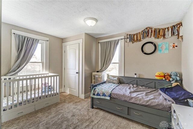 357 High St, Wilmington, OH 45177 - bedroom featuring a textured ceiling, light carpet, and baseboards