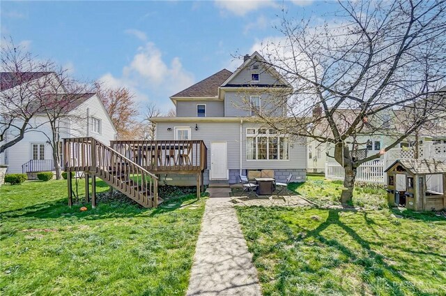 357 High St, Wilmington, OH 45177 - rear view of property featuring a wooden deck, stairway, a patio area, an outdoor structure, and a lawn
