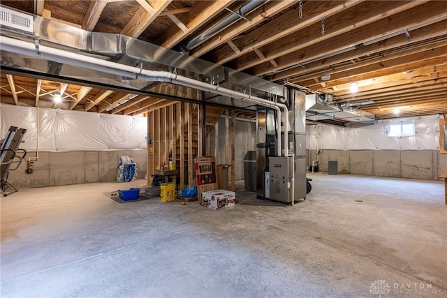 basement with visible vents and heating unit