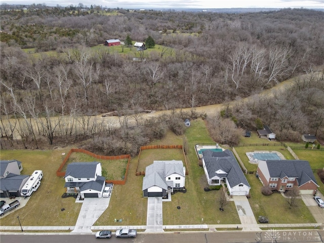 drone / aerial view with a forest view and a residential view