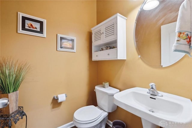 bathroom featuring toilet and a sink