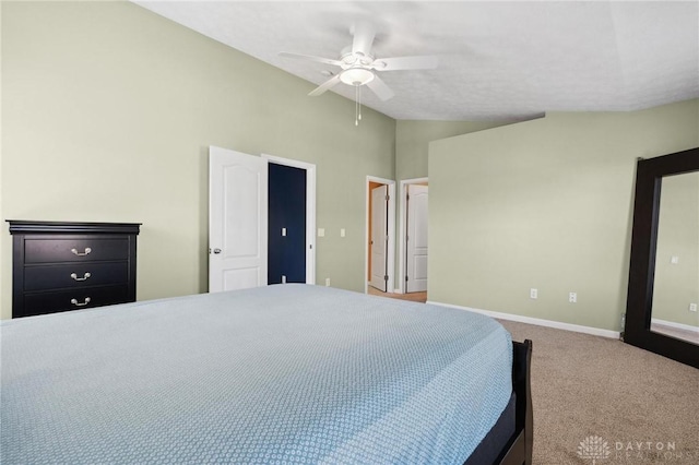 carpeted bedroom featuring baseboards, a ceiling fan, and vaulted ceiling
