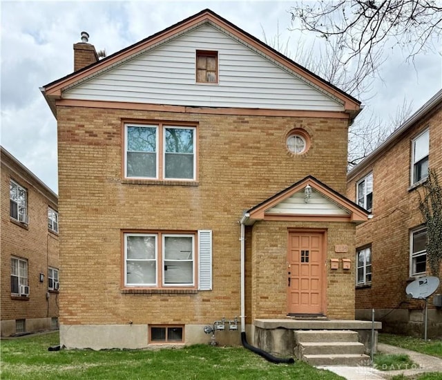 1029 Cumberland Ave, Dayton, OH 45406 - view of front facade with a chimney, a front lawn, and brick siding