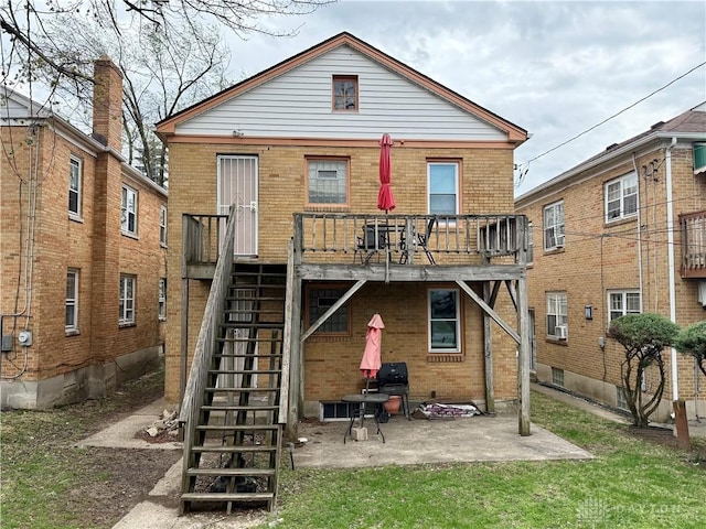 1029 Cumberland Ave, Dayton, OH 45406 - rear view of house with stairway, a patio, brick siding, and a wooden deck