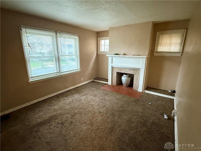 1029 Cumberland Ave, Dayton, OH 45406 - unfurnished living room with carpet, a brick fireplace, a textured ceiling, and baseboards