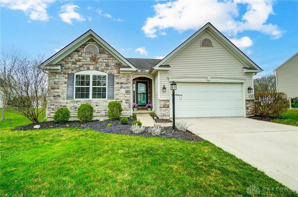 ranch-style home featuring a front lawn, stone siding, a garage, and concrete driveway