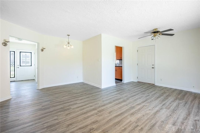 645 Brookfield Rd, Dayton, OH 45429 - unfurnished living room featuring light wood-type flooring, a chandelier, ceiling fan, and a textured ceiling