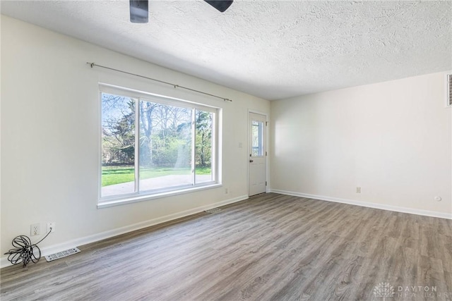 645 Brookfield Rd, Dayton, OH 45429 - empty room featuring wood finished floors, healthy amount of natural light, and a textured ceiling