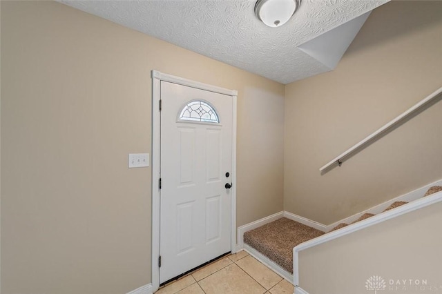 721 Trafalgar Ct, Middletown, OH 45044 - entryway with baseboards, light tile patterned floors, stairs, and a textured ceiling