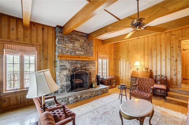 4600 Brown Rd, Sugarcreek Township, OH 45440 - living area with beam ceiling, hardwood / wood-style flooring, wooden walls, a fireplace, and a ceiling fan