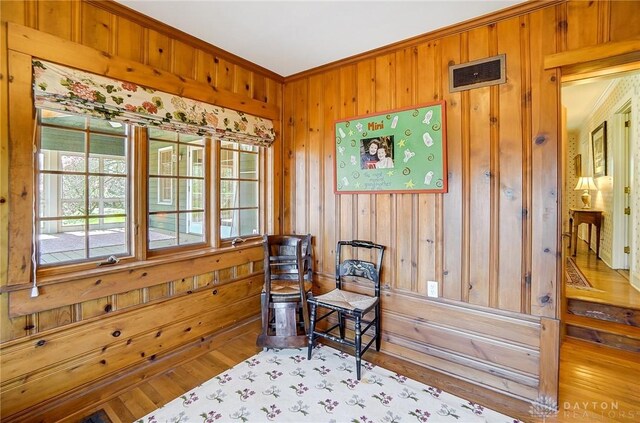 4600 Brown Rd, Sugarcreek Township, OH 45440 - sitting room with plenty of natural light, ornamental molding, wooden walls, and wood finished floors