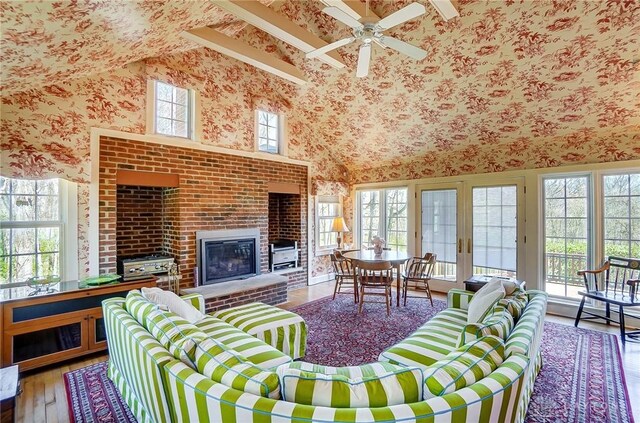 4600 Brown Rd, Sugarcreek Township, OH 45440 - living area with wallpapered walls, a fireplace, hardwood / wood-style flooring, ceiling fan, and a towering ceiling
