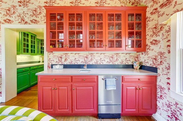 4600 Brown Rd, Sugarcreek Township, OH 45440 - kitchen with wallpapered walls, light countertops, light wood-style floors, a sink, and glass insert cabinets
