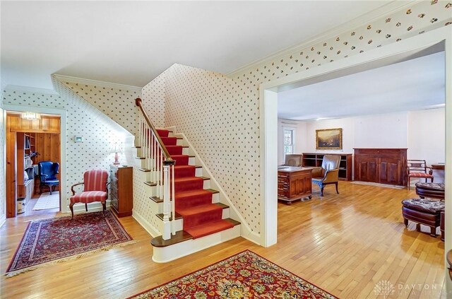 4600 Brown Rd, Sugarcreek Township, OH 45440 - stairway featuring ornamental molding, wallpapered walls, and hardwood / wood-style flooring