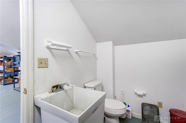 4600 Brown Rd, Sugarcreek Township, OH 45440 - bathroom featuring a sink, toilet, vaulted ceiling, and tile patterned flooring