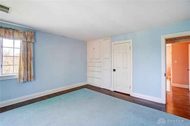 4600 Brown Rd, Sugarcreek Township, OH 45440 - unfurnished bedroom with baseboards and dark wood finished floors