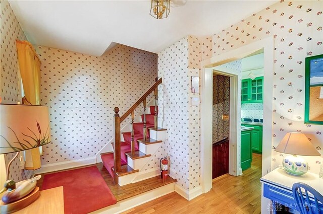 4600 Brown Rd, Sugarcreek Township, OH 45440 - stairs featuring wallpapered walls, wood finished floors, and baseboards