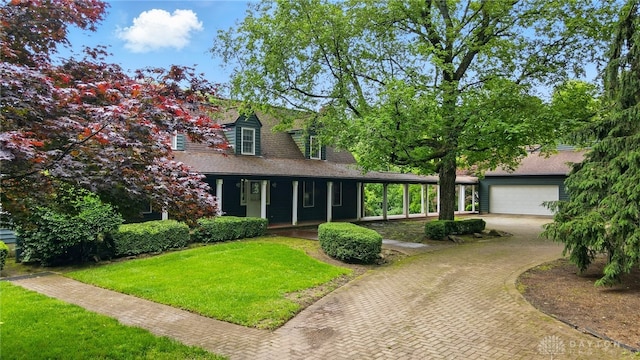 4600 Brown Rd, Sugarcreek Township, OH 45440 - view of front facade featuring covered porch, decorative driveway, a front yard, an attached garage, and a shingled roof