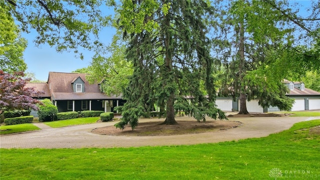 4600 Brown Rd, Sugarcreek Township, OH 45440 - cape cod house featuring driveway, a front yard, and a garage