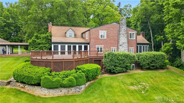 4600 Brown Rd, Sugarcreek Township, OH 45440 - rear view of property with a chimney, a deck, and a lawn