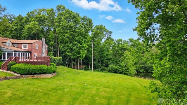 4600 Brown Rd, Sugarcreek Township, OH 45440 - view of grassy yard featuring a wooden deck, stairway, and a sunroom