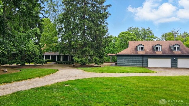 4600 Brown Rd, Sugarcreek Township, OH 45440 - view of green lawn with driveway and a garage