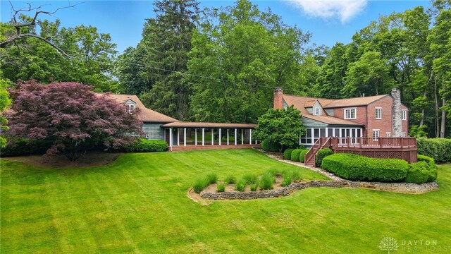 4600 Brown Rd, Sugarcreek Township, OH 45440 - view of grassy yard with a sunroom, a wooden deck, and stairway