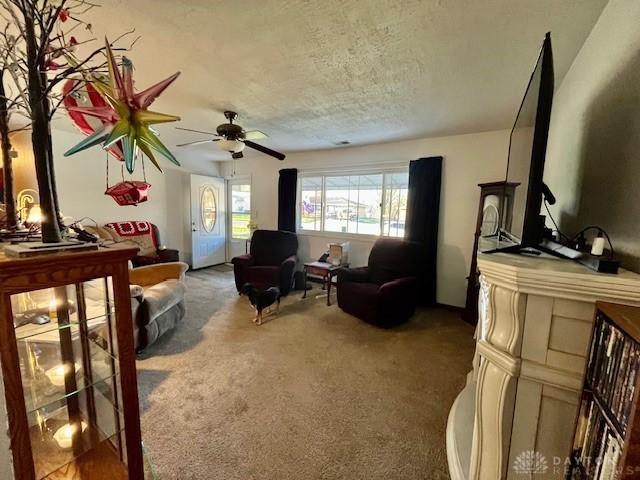 interior space with a ceiling fan and a textured ceiling