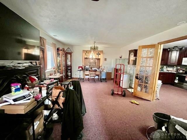 miscellaneous room with a chandelier and carpet