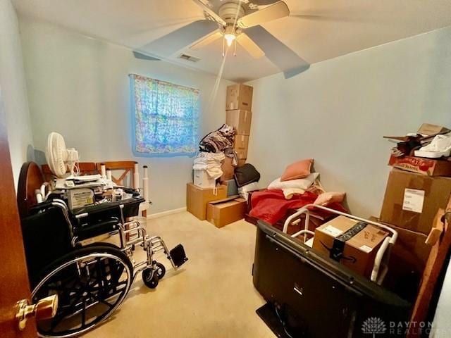 interior space featuring visible vents, a ceiling fan, and carpet floors