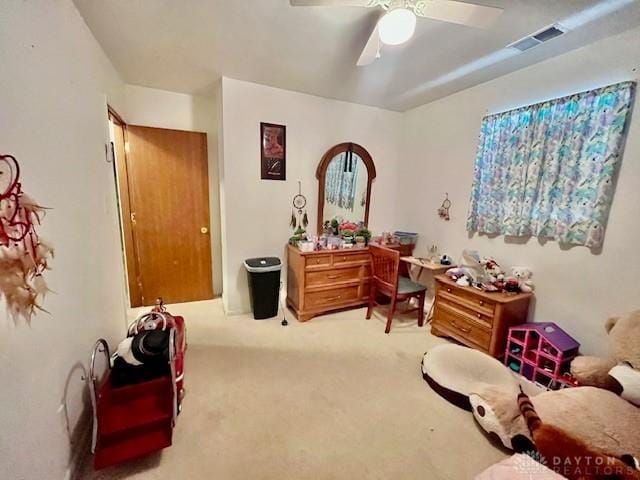 office featuring carpet flooring, a ceiling fan, and visible vents